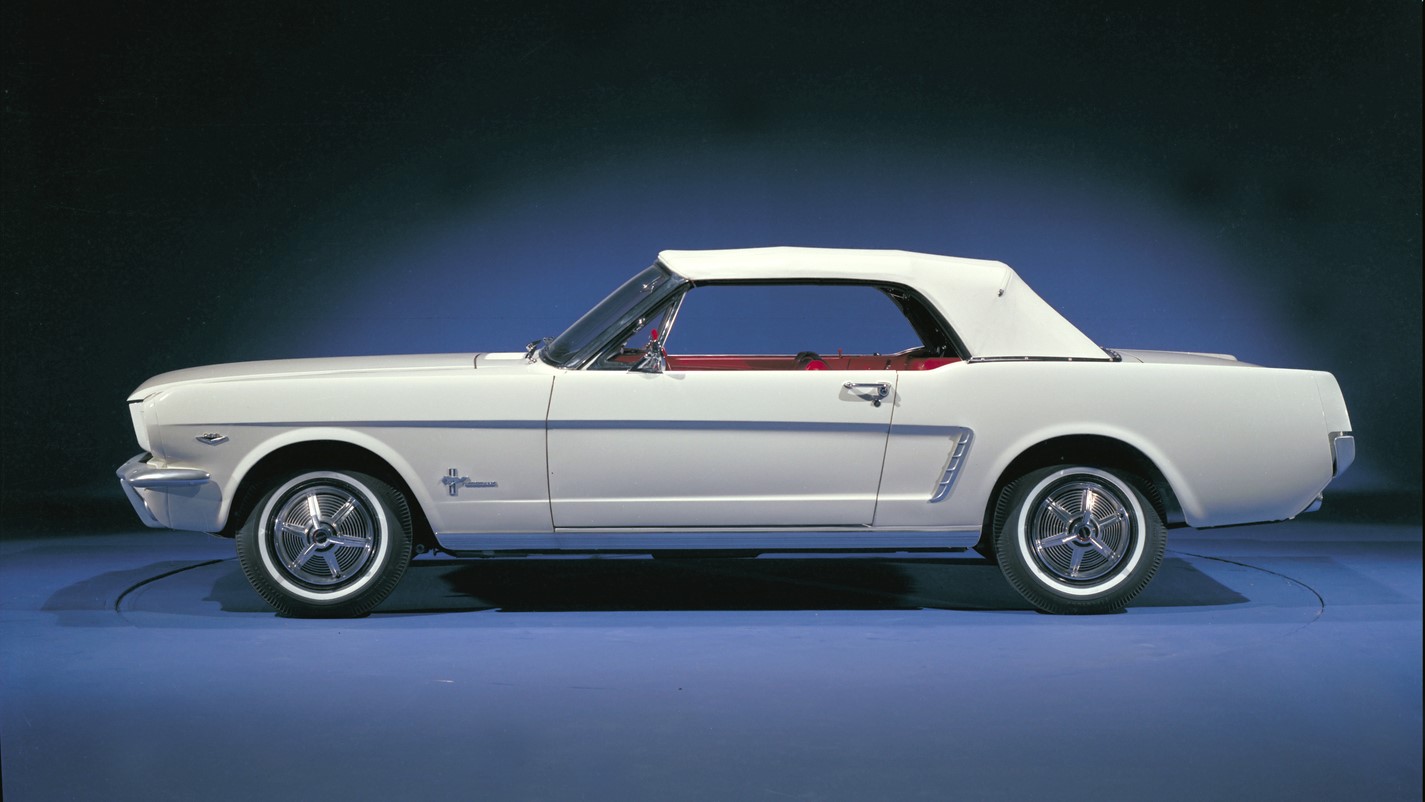 A white 1965 Ford Mustang convertible.
