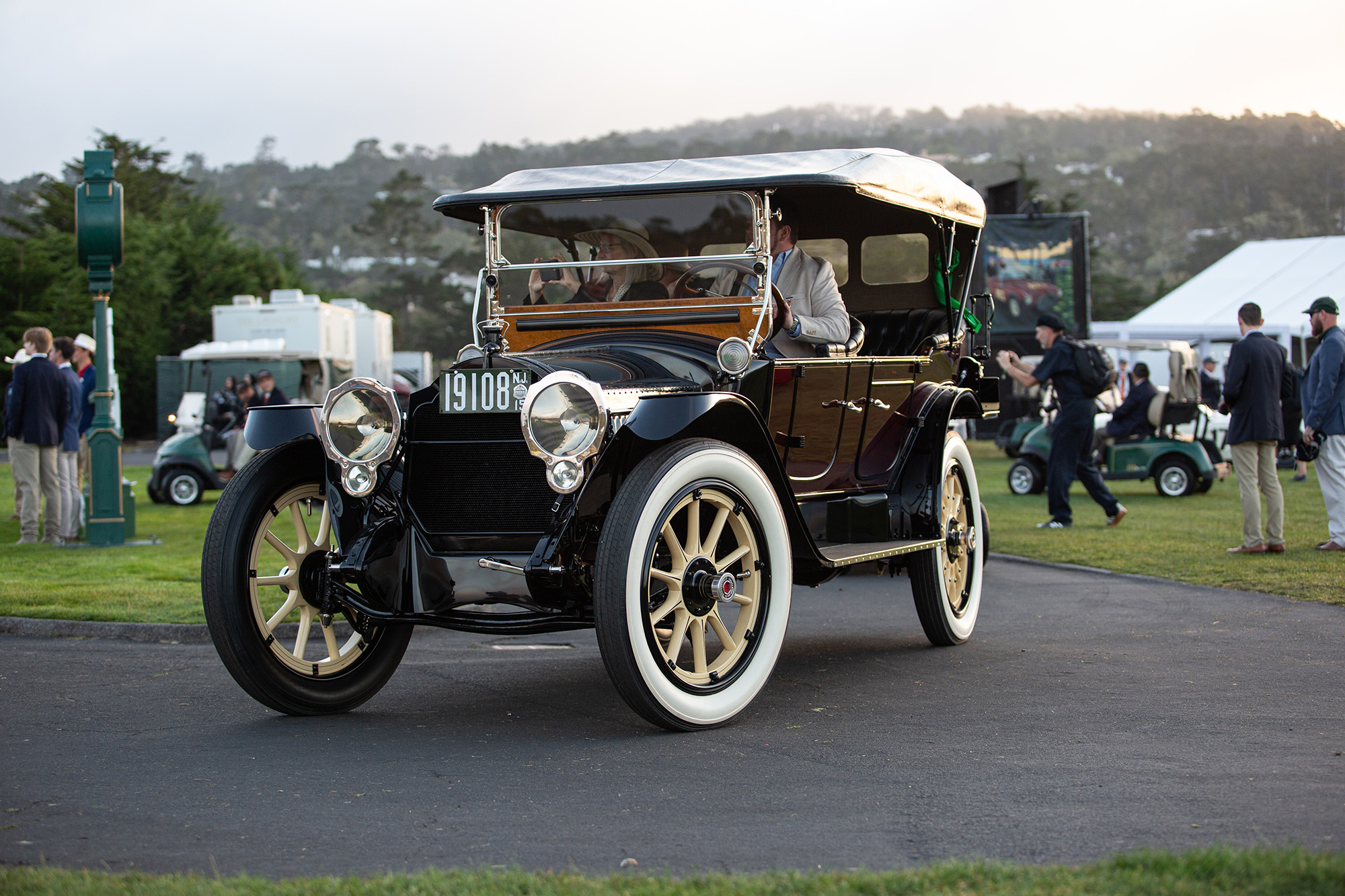 1915 Packard 3-38 Six Five-Passenger Phaeton, front quarter, top up, entering the Pebble Beach Concours lawn