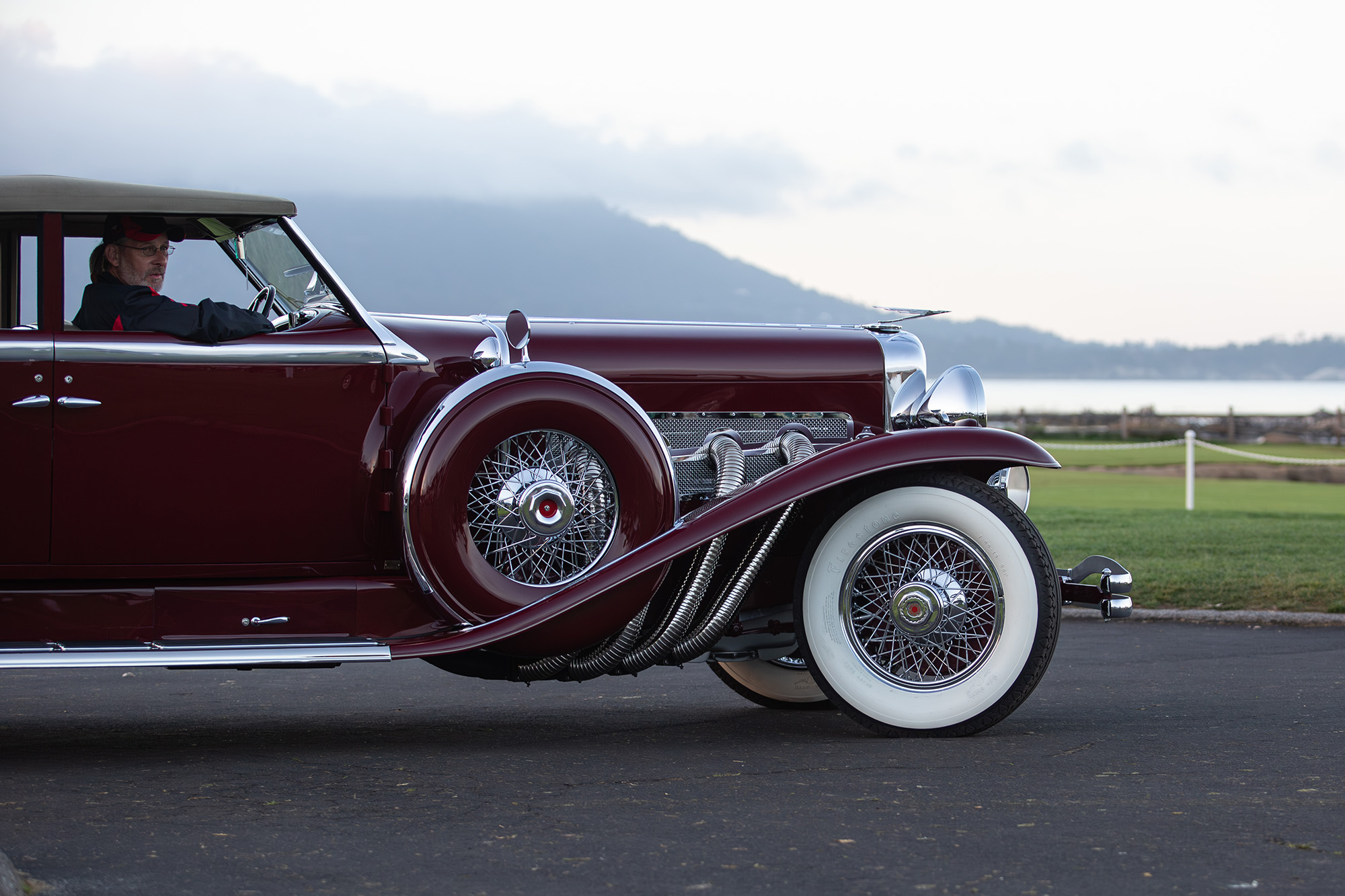 1930 Duesenberg Model J Murphy Convertible Berline, partial side view, showing the Pebble Beach grounds