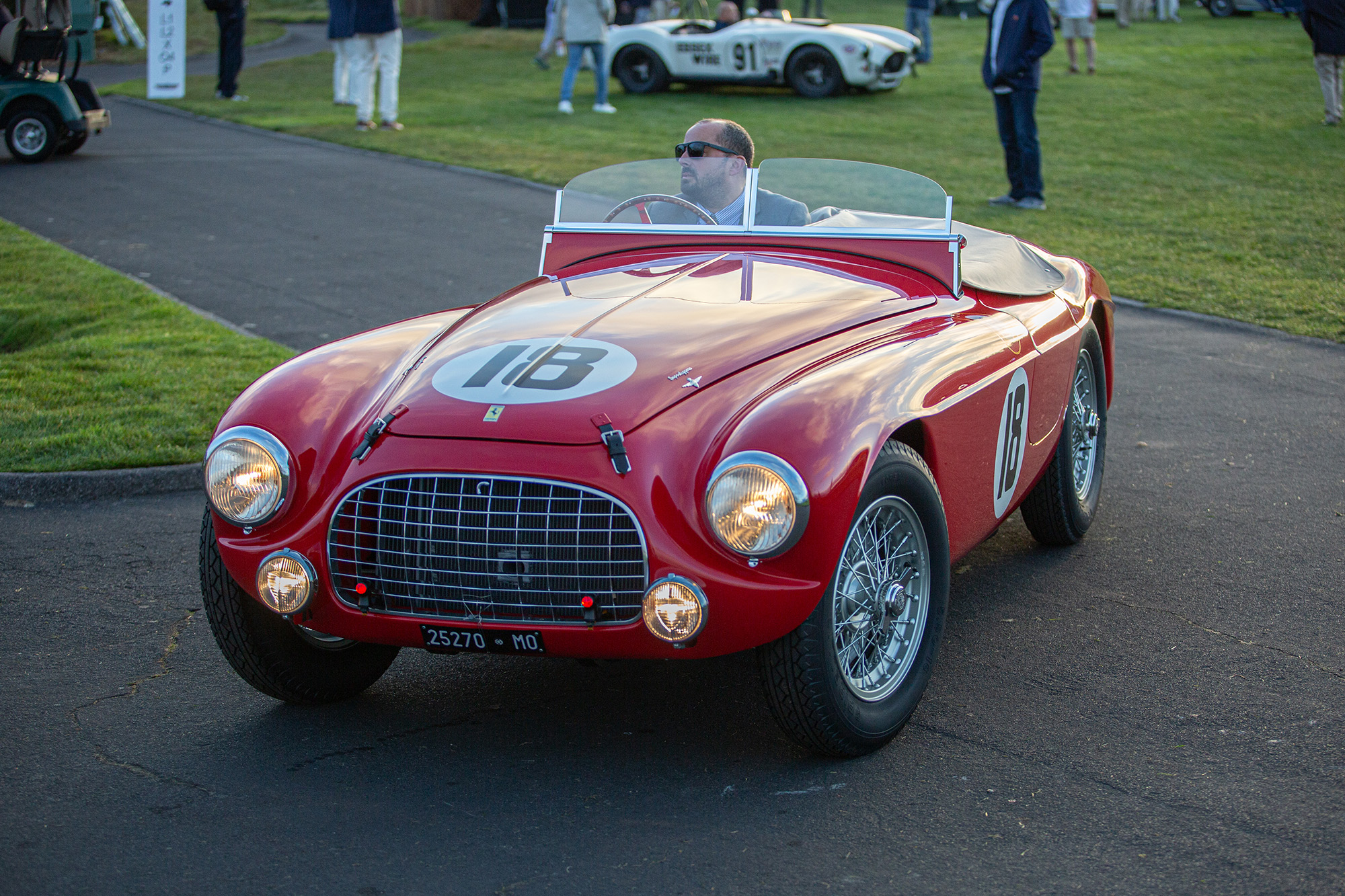 1951 Ferrari 340 America Barchetta, front quarter view, driving onto the grass at Pebble Beach concours