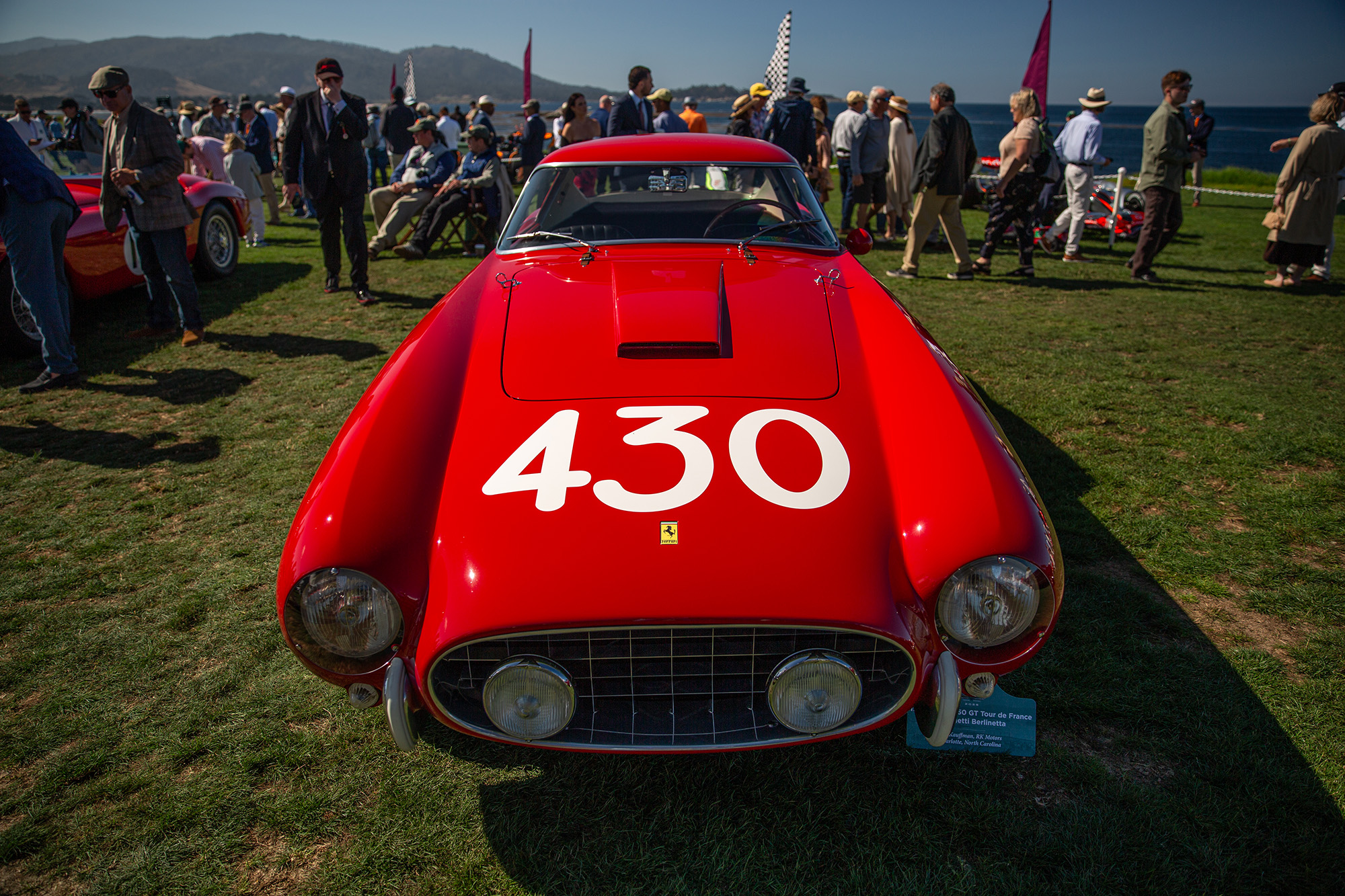 1957 Ferrari 205 GT Tour de France, front view, with Pebble Beach crowd behind car