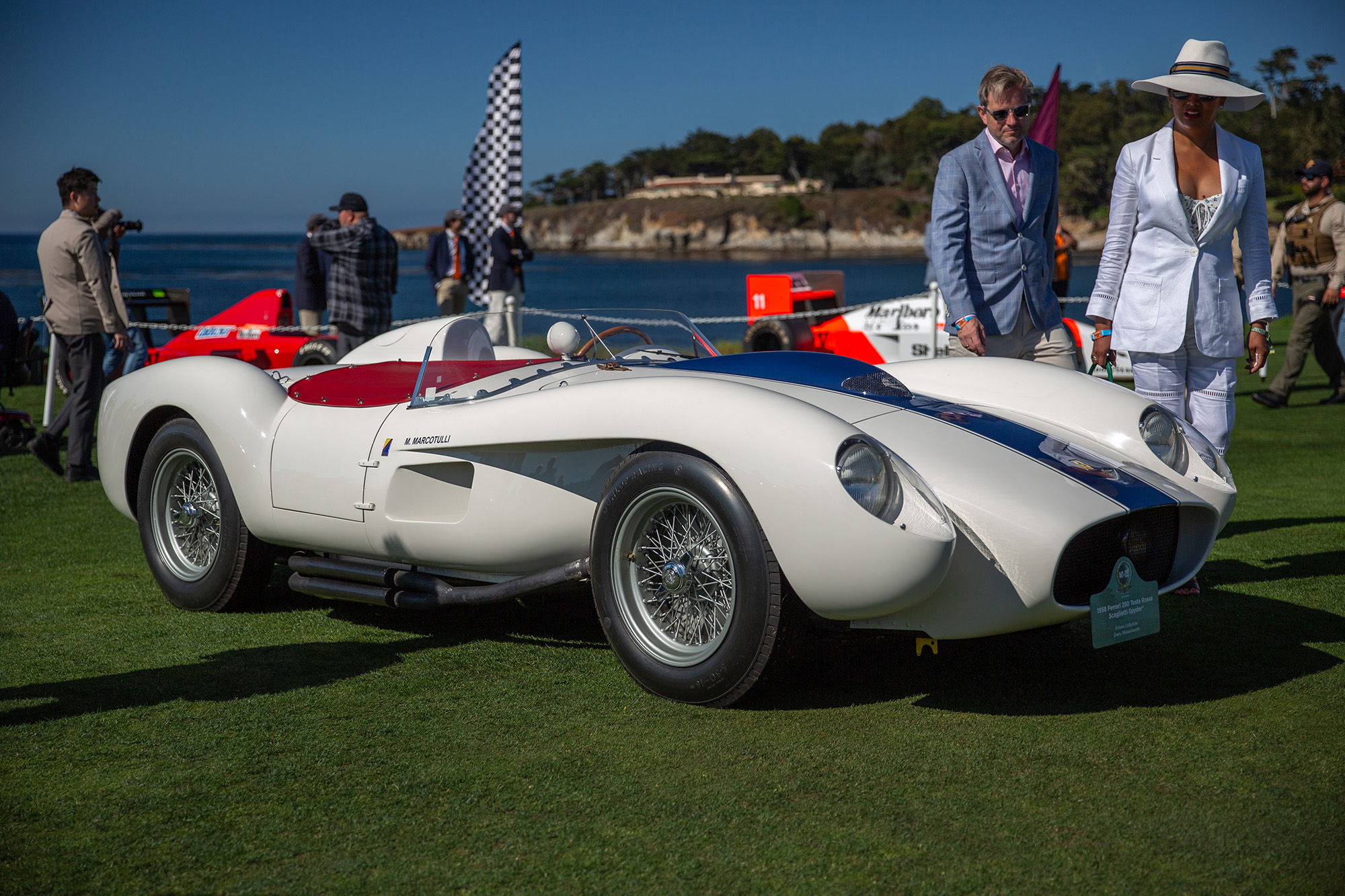 1958 Ferrari 250 Testa Rossa Spyder, white with blue stripe, on the grass at Pebble Beach Concours