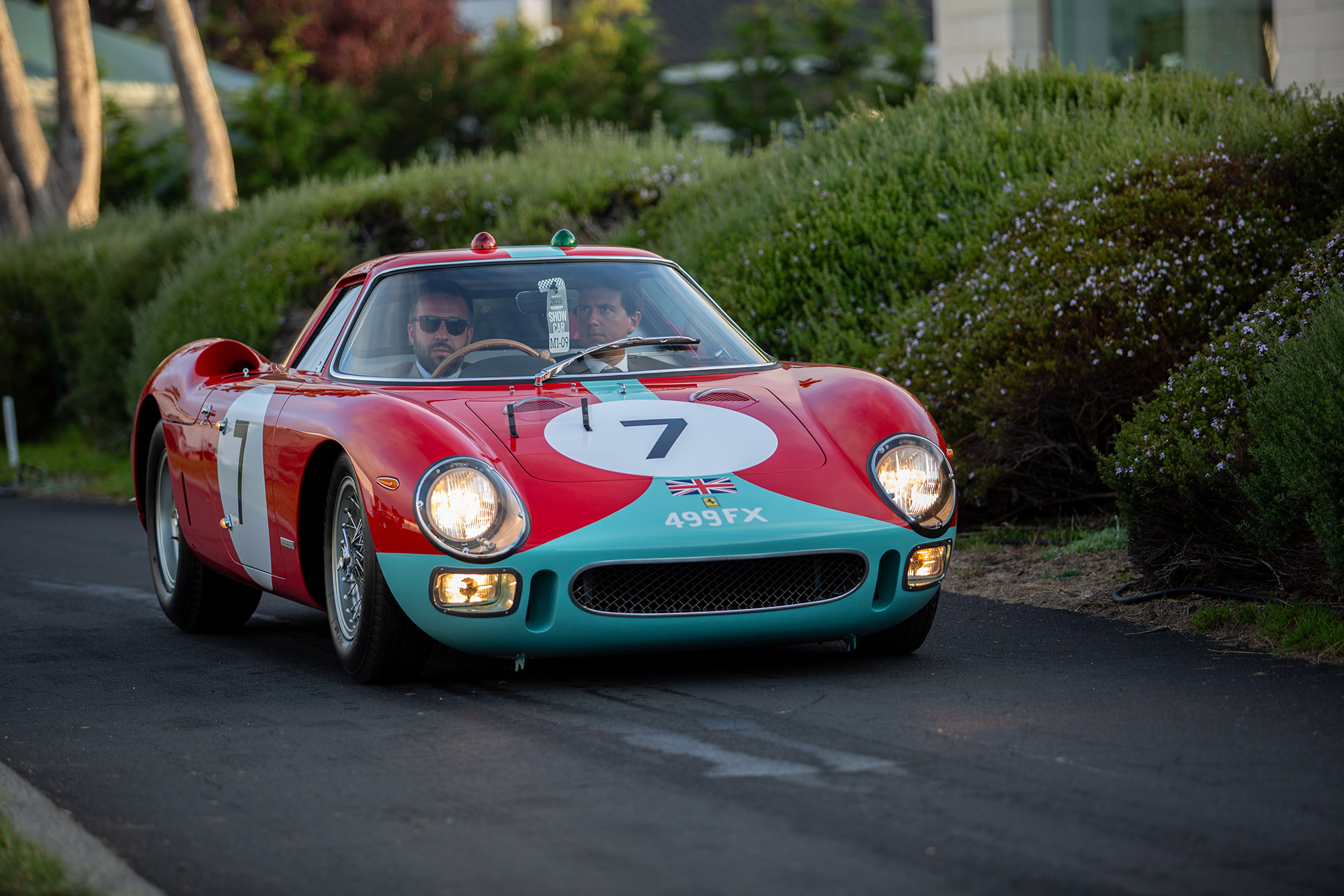1964 Ferrari 250 LM, front quarter, on paved path leading to Pebble Beach show field