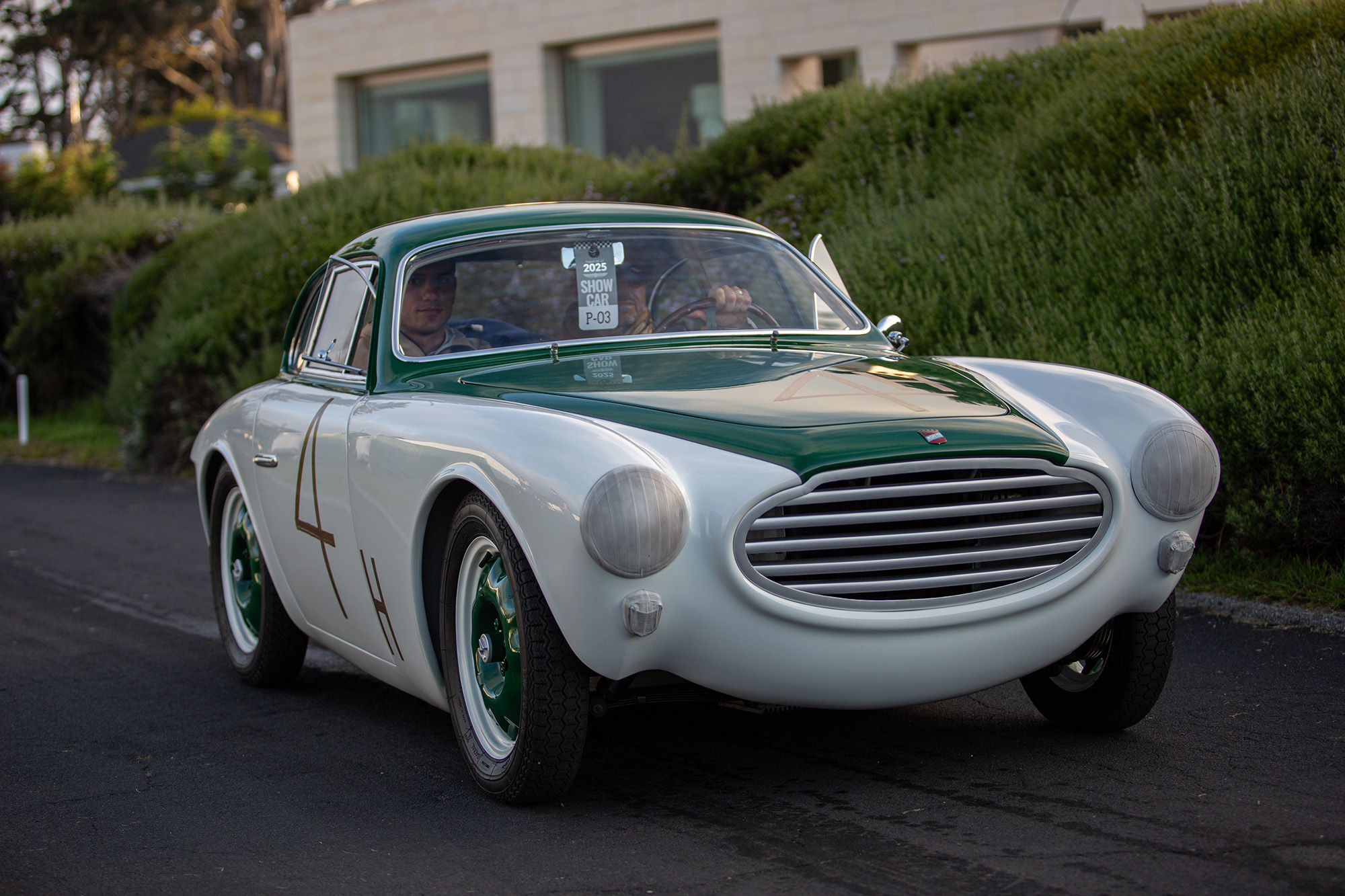 1954 Moretti 750 Gran Sport Berlinetta, white with green center stripe, on pavement, front quarter, entering Pebble Beach Concours show field