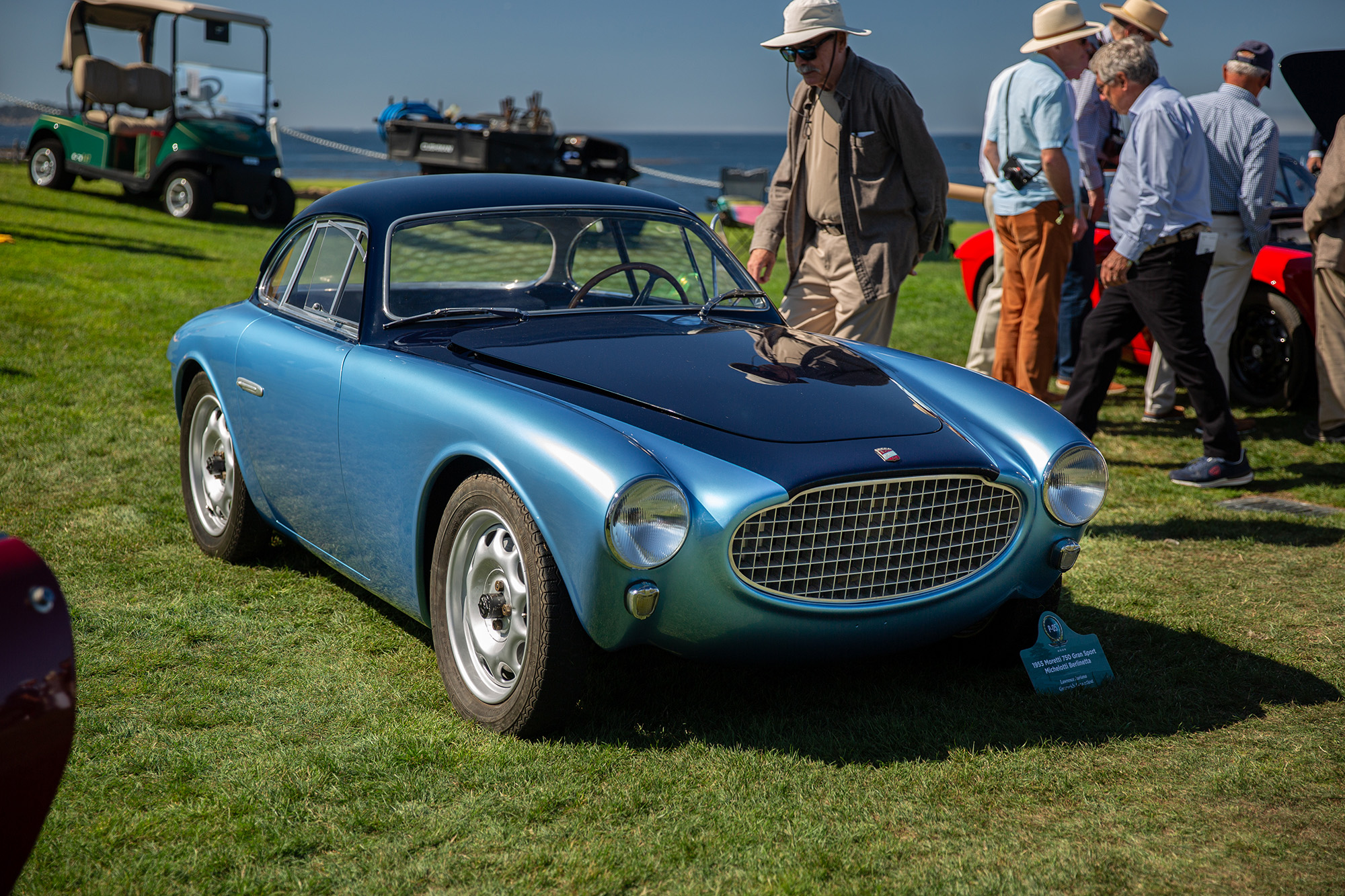 1955 Moretti 750 Gran Sport Berlinetta, front quarter, two tone blue, on the grass at Pebble Beach