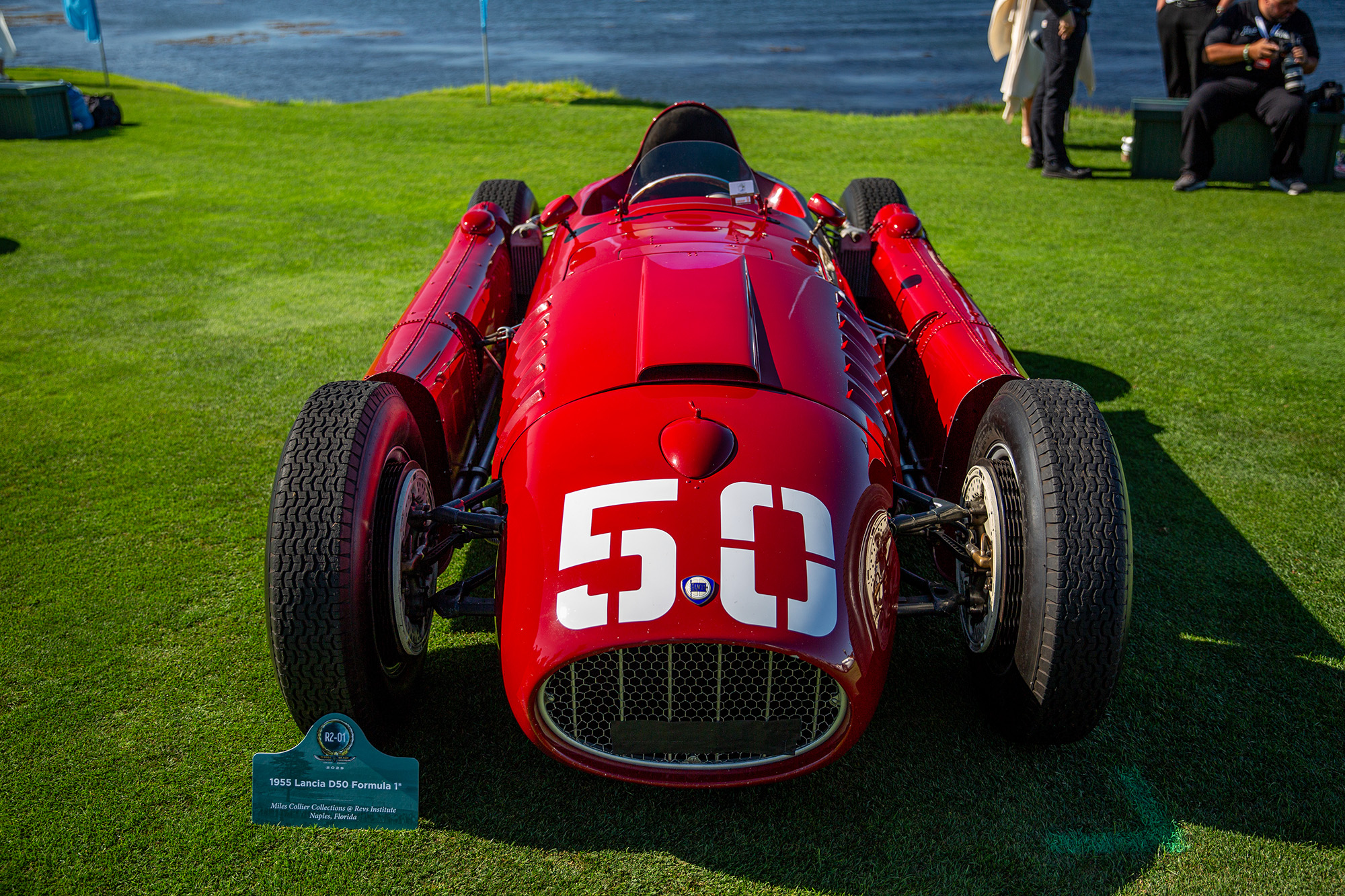 1955 Lancia D50, front view, on the lawn at Pebble Beach Concours with the ocean behind it