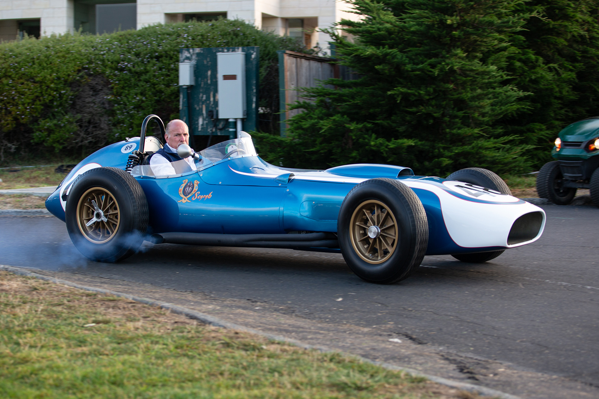 1960 Scarab Formula 1, side view, driving on pavement, smoke from exhaust