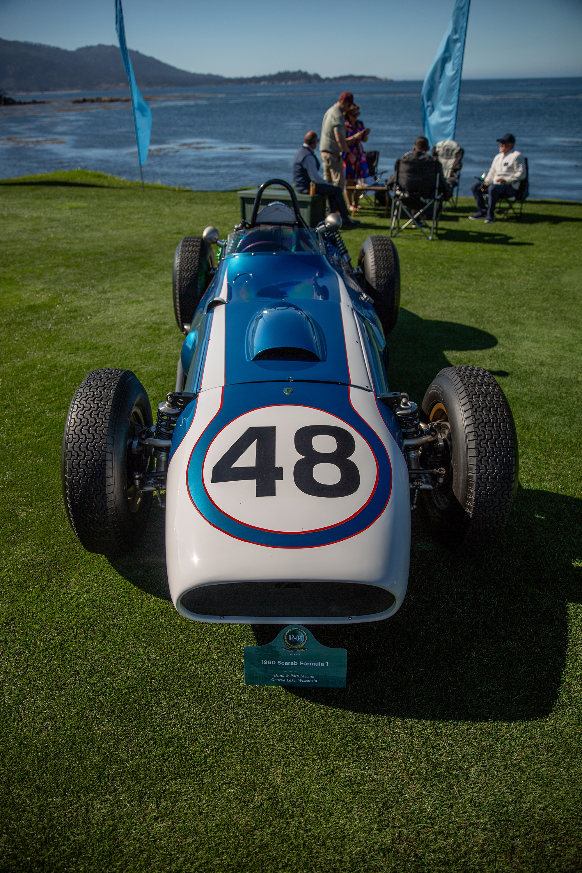 1960 Scarab Formula 1, front view, parked on grass, ocean behind